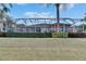 Home with a screened enclosure, lush landscaping, and a large yard at 5253 Brighton Shore Dr, Apollo Beach, FL 33572