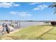Waterfront home with a grassy backyard, dock, and boat lift at 5253 Brighton Shore Dr, Apollo Beach, FL 33572