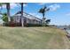 Landscaped backyard with screened patio and water views at 5253 Brighton Shore Dr, Apollo Beach, FL 33572