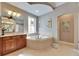 Elegant bathroom with soaking tub, walk-in shower, and dual vanities at 5253 Brighton Shore Dr, Apollo Beach, FL 33572