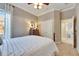 Bedroom with white bedding and view into another room at 5253 Brighton Shore Dr, Apollo Beach, FL 33572