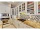 White cabinets, mosaic backsplash, and stainless steel appliances at 5253 Brighton Shore Dr, Apollo Beach, FL 33572