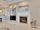 Living room with fireplace, built-in shelving, and TV at 5253 Brighton Shore Dr, Apollo Beach, FL 33572