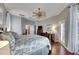 Spacious main bedroom with hardwood floors and access to a balcony at 5253 Brighton Shore Dr, Apollo Beach, FL 33572