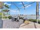 Outdoor patio with seating area and fire pit overlooking the water at 5253 Brighton Shore Dr, Apollo Beach, FL 33572