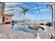 Inviting kidney shaped pool and spa with a screened enclosure at 5253 Brighton Shore Dr, Apollo Beach, FL 33572