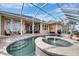 Resort style pool and spa with screened enclosure and water views at 5253 Brighton Shore Dr, Apollo Beach, FL 33572