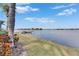 Scenic waterfront view with grassy area and dock at 5253 Brighton Shore Dr, Apollo Beach, FL 33572