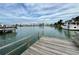 Private wooden dock offering waterfront access and views at 6437 1St Palm Pt, St Pete Beach, FL 33706