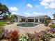 Charming home with a kidney-shaped pool and solar panels at 725 Capri Blvd, Treasure Island, FL 33706