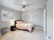 Cozy bedroom with a double bed, ceiling fan, and sliding barn door at 725 Capri Blvd, Treasure Island, FL 33706