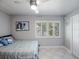 Comfortable bedroom with a ceiling fan and large window at 725 Capri Blvd, Treasure Island, FL 33706