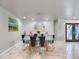 Bright dining room features glass top table and modern light fixture at 725 Capri Blvd, Treasure Island, FL 33706
