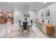 Elegant dining room with glass table, modern light fixture, and built-in buffet at 725 Capri Blvd, Treasure Island, FL 33706