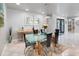 Modern dining room with glass table and buffet, adjacent to entryway at 725 Capri Blvd, Treasure Island, FL 33706