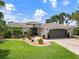 Attractive home exterior featuring a landscaped yard and updated facade at 725 Capri Blvd, Treasure Island, FL 33706