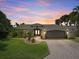 Stunning curb appeal with a landscaped yard, paver driveway, and updated facade at 725 Capri Blvd, Treasure Island, FL 33706