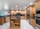 Large kitchen island, stainless steel appliances and light wood cabinets at 725 Capri Blvd, Treasure Island, FL 33706