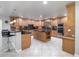 Updated kitchen features stainless steel appliances and an island with seating at 725 Capri Blvd, Treasure Island, FL 33706