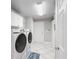 Clean laundry room with washer, dryer, and ample storage at 725 Capri Blvd, Treasure Island, FL 33706