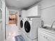 Bright laundry room with washer, dryer, sink, and cabinets at 725 Capri Blvd, Treasure Island, FL 33706