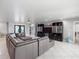 Open living area featuring a large sectional sofa and built-in entertainment center at 725 Capri Blvd, Treasure Island, FL 33706