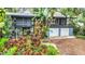 House with a screened porch and two-car garage, surrounded by trees at 751 Pinellas Point S Dr, St Petersburg, FL 33705