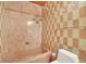 Bathroom with checkered tile and shower/tub combo at 751 Pinellas Point S Dr, St Petersburg, FL 33705
