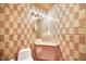 Bathroom with checkered tile and corner vanity at 751 Pinellas Point S Dr, St Petersburg, FL 33705