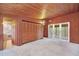 Bedroom with built-in wooden closet and access to a balcony at 751 Pinellas Point S Dr, St Petersburg, FL 33705