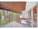 Covered porch with stairs to lower level and backyard views at 751 Pinellas Point S Dr, St Petersburg, FL 33705