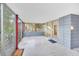 Enclosed porch with terrazzo flooring, offering access to the home and backyard views at 751 Pinellas Point S Dr, St Petersburg, FL 33705