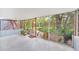 Enclosed porch with lush garden views, creating a peaceful outdoor space at 751 Pinellas Point S Dr, St Petersburg, FL 33705