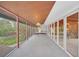 Covered porch with access to kitchen and backyard, perfect for relaxing at 751 Pinellas Point S Dr, St Petersburg, FL 33705