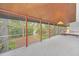 Enclosed porch overlooking a tranquil backyard, providing ample natural light at 751 Pinellas Point S Dr, St Petersburg, FL 33705