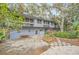 Mid-century modern home with lush landscaping and a patio at 751 Pinellas Point S Dr, St Petersburg, FL 33705