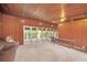 Gathering room with wood paneled walls and access to backyard at 751 Pinellas Point S Dr, St Petersburg, FL 33705