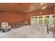 Spacious Gathering room featuring wood paneling and large windows at 751 Pinellas Point S Dr, St Petersburg, FL 33705