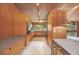 Mid-century modern kitchen with wood cabinets and appliances at 751 Pinellas Point S Dr, St Petersburg, FL 33705