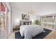 Bright main bedroom featuring hardwood floors, neutral paint, a large windows, with modern décor at 751 Pinellas Point S Dr, St Petersburg, FL 33705