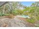 Relaxing kidney-shaped pool with stone waterfall feature at 751 Pinellas Point S Dr, St Petersburg, FL 33705
