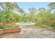 Inviting kidney-shaped pool surrounded by lush landscaping at 751 Pinellas Point S Dr, St Petersburg, FL 33705
