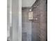 Shower stall with dark gray tiles and a glass enclosure at 751 Pinellas Point S Dr, St Petersburg, FL 33705