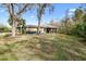 Landscaped backyard with lush lawn and mature trees at 9116 Exposition Dr, Tampa, FL 33626