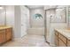 Bathroom with double vanity, tub, and shower at 9116 Exposition Dr, Tampa, FL 33626