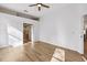 Bright bedroom with wood-look floors and ceiling fan at 9116 Exposition Dr, Tampa, FL 33626