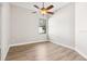Bright bedroom with wood-look floors and ceiling fan at 9116 Exposition Dr, Tampa, FL 33626