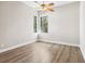 Spacious bedroom with wood-look floors and large windows at 9116 Exposition Dr, Tampa, FL 33626