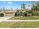 Single-story home with palm trees and a two-car garage at 9116 Exposition Dr, Tampa, FL 33626