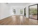 Spacious living room with hardwood floors and sliding glass doors at 9116 Exposition Dr, Tampa, FL 33626